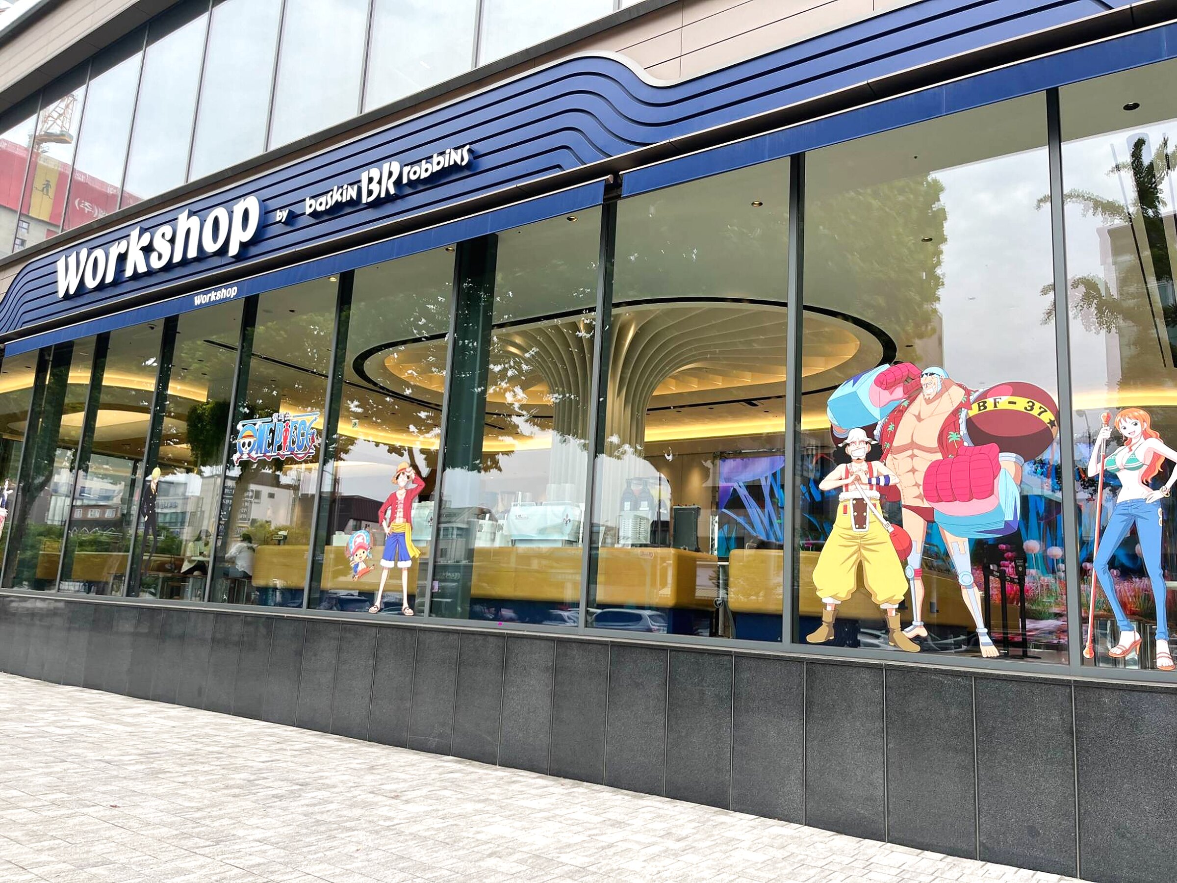 Workshop storefront with the One Piece crew in the windows, finished